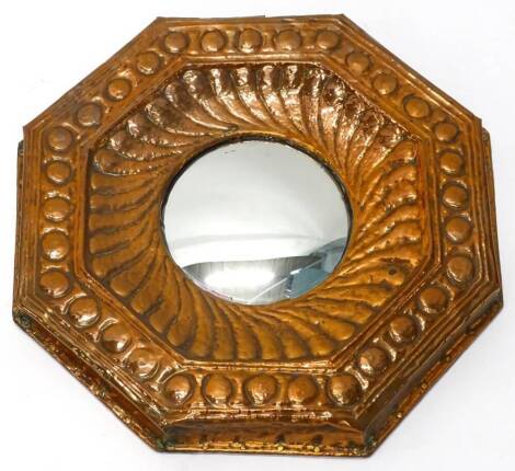 An Arts and Crafts embossed copper octagonal wall mirror, with convex mirror plate, 54cm W.