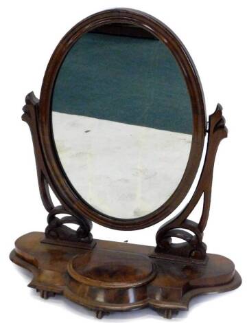 A Victorian mahogany dressing table mirror, the oval plate on pierced and carved supports, the shaped base with a hinged trinket compartment on lobbed feet, 67cm W.