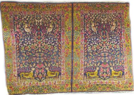 A Persian pictorial design rug, decorated in two sections, each with stags, birds and multi colour flowers with one wide and one narrow border, 109cm x 76cm.