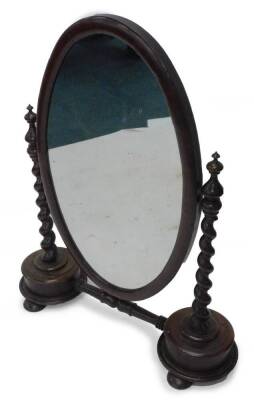 A large Victorian mahogany dressing table mirror, the oval plate on spirally turned supports, joined by a turned stretcher on bun feet, 88cm W.