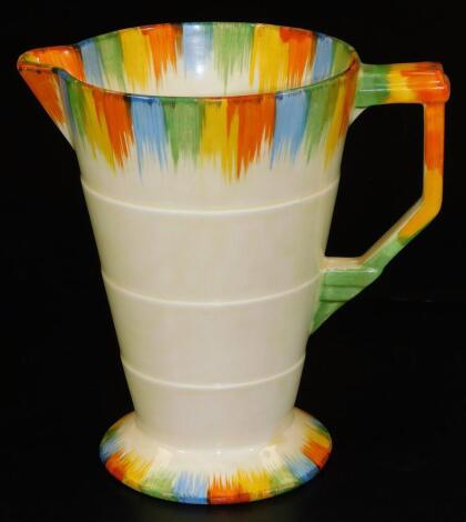 A mid 20thC Grindley Art Deco pottery jug, with splash decoration predominately in green, yellow, orange and blue, with a ribbed body and angular handle, printed marks beneath, 18cm H.