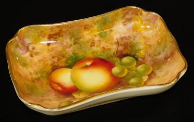 A Royal Worcester pin dish, by Frank Roberts, handpainted with autumnal fruits, grapes and apples, in a naturalistic setting, 1949, printed marks beneath, 12cm W.