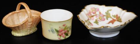 Royal Worcester blush ivory items, comprising a small basket, c1896, small pin tray, shape code 1345, c1890 and a small bowl, c1908. (3)