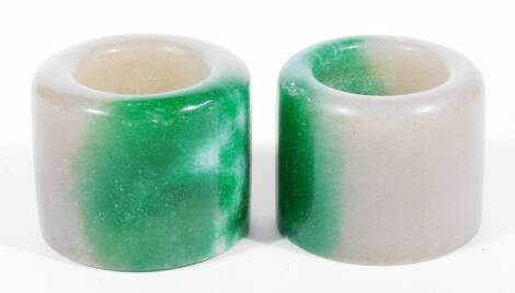 Two Chinese jade archers' rings, in green and white, each approx 4cm H. (2)