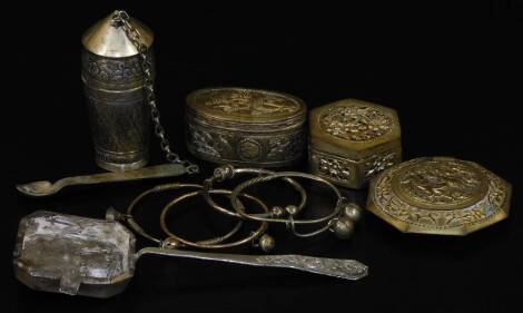 Asian white metal objects, inc. octagonal cricket box, opium bottle with spoon, four torc or bangles and a Chinese opium pan. (9)