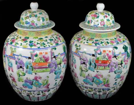 A large pair of bulbous Chinese porcelain vases and covers, the bodies decorated with panels of figures in interior setting, all in pinks, greens and blues, with domed lids, red seal marks beneath, 56cm H. (2)