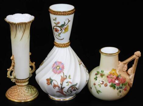 A Royal Worcester blush ivory vase, of ribbed form, with a central raised gilt collar, handpainted with flowers on an ivory ground, no. 1452, 17cm H, a further Royal Worcester vase no. 1556, another 1138. (3)