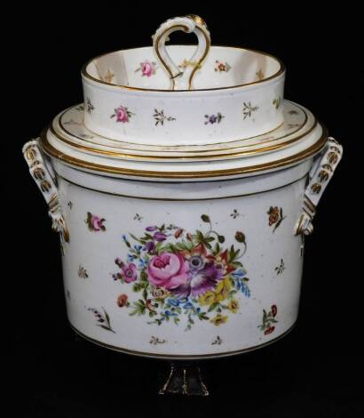 A 19thC Paris porcelain ice pail cover and liner, of circular form with moulded handles on shaped feet, decorated with bouquets of flowers broken by further flowers and petals, with moulded handles and gilt highlights with entwined central handle, unmarke
