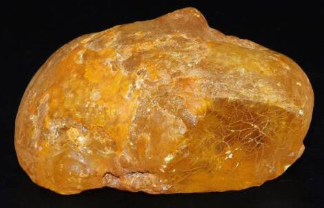 A large piece of clear amber coloured petrified tree resin, 10cm L, 197g.