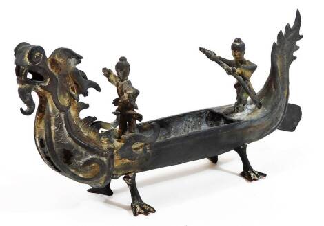 A Chinese bronze model of a boat, of dragon form set with oars man and leader, unmarked, 17cm H.