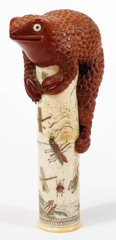 A Japanese bone column with applied toad figural surmount, the main body decorated with insects, on a circular foot, oval character mark beneath, 20cm H.