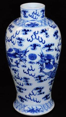 A 19thC Chinese blue and white porcelain baluster vase, decorated with four clawed dragons chasing the flaming pearl among clouds, the base bearing a four character Kangxi mark but later, 33cm H.