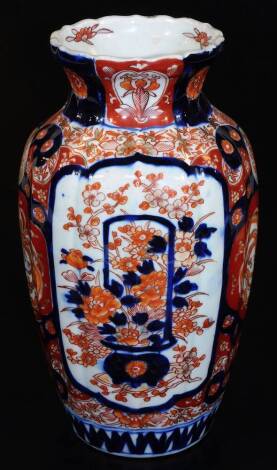 A Meiji period Japanese Imari baluster vase, decorated with panels of flowers predominately in orange and blue, some decoration to the interior rim, unmarked, 32cm H.