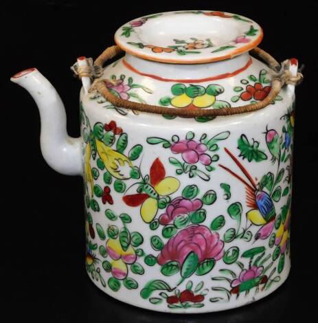 A Chinese late Qing porcelain tea kettle, of shouldered form with lid and bound wire handle, profusely decorated with flowers predominantly in pink, green and yellow, 16cm H, in a fitted wicker case.