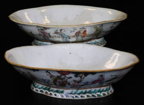 A 19thC Chinese porcelain lobed dish, decorated with mythical figures in flowing robes before fence, predominantly enamelled in orange, green and blue, on a shaped foot with water and wave border, 27cm W and another similar with red seal mark beneath, 19t