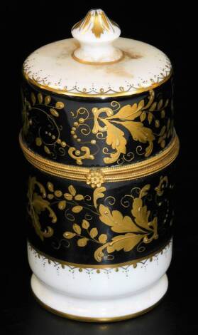 A Paris enamel cylindrical jar and cover, with gilt mounts, the body with a black and white ground, set with various leaves in further gilt colours, signed beneath, 15cm H.