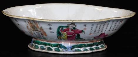 A 19thC Chinese porcelain lobed dish, decorated with mythical figures and calligraphy, predominantly enamelled in open, green and blue, on a shaped foot with water and wave border, 24cm W.