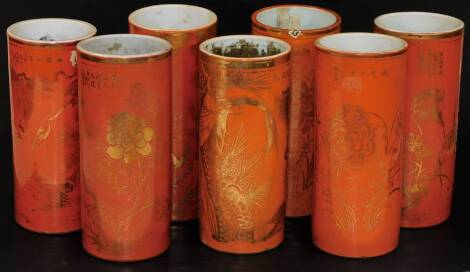 Seven various Chinese porcelain spill vases brush pots, of cylindrical form in orange with gilt highlights showing flowers and calligraphy, etc. 27cm H, some marked. (7)