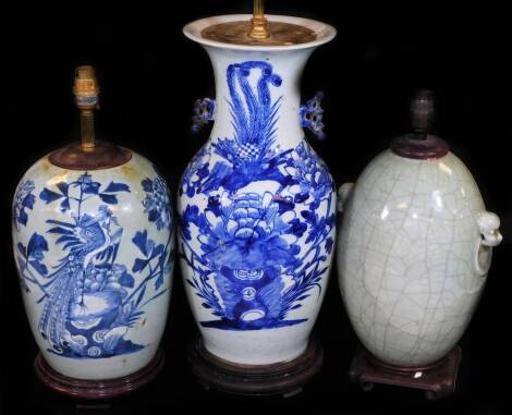 A Chinese blue and white lamp vase, of shouldered circular form, profusely decorated with exotic bird and flowers on a wooden plinth base with lamp fitting, 59cm H and two others lamps to include a celadon type and another decorated with flowers. (3)