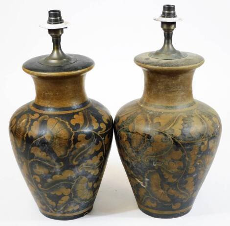 A pair of pottery lamps, of shouldered form, profusely decorated with leaves with electrical fitting, 48cm H. (2)