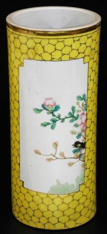 A Chinese porcelain cylindrical spill vase decorated with panels of tree peony, on a yellow ground with gilt highlights, 28cm H.