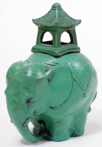 A 1930s-1950's Japanese soft metal koro and cover, shaped as an elephant with caparison and howdah, cold painted in green, 11.2cm H.