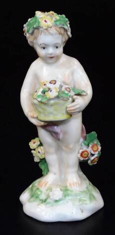 A Derby figure of putti, holding a basket of flowers, c1770, 11cm H.