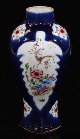 A late 19thC Chinese porcelain baluster vase, decorated with leaf shaped panels of birds in famille rose colours on a blue ground, 25cm H.