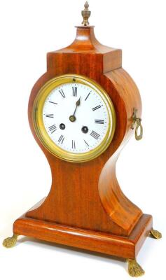 A 19thC mahogany balloon clock, the shaped case on an inverted stem and platform base, terminating in brass hairy paw feet and flanked by shaped handles with a 12cm Dia. enamel dial with Roman numerals revealing an 8-day movement, 39cm H, with key.