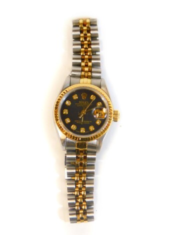 A ladys Rolex date adjust bi-metal wristwatch, oyster perpetual baton pointers and shaped numerals set with small white stones,effaced with crown marked Rolex, with bicoloured strap, fitted case with paperwork receipts and outer box, booklet No. 69173, fa