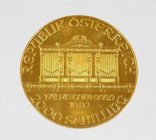 A 1992 Austrian gold Philharmonic coin, marked 1 unze gold, 999.9, 2000 Schilling.