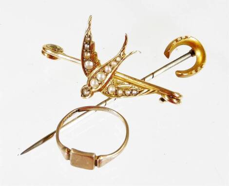 Three items of various jewellery, comprising a 9ct gold signet ring, 1g, a horseshoe stick pin, a yellow metal swallow brooch, set with seed pearls, unmarked, 4cm wide, 3.2g all in. (3)