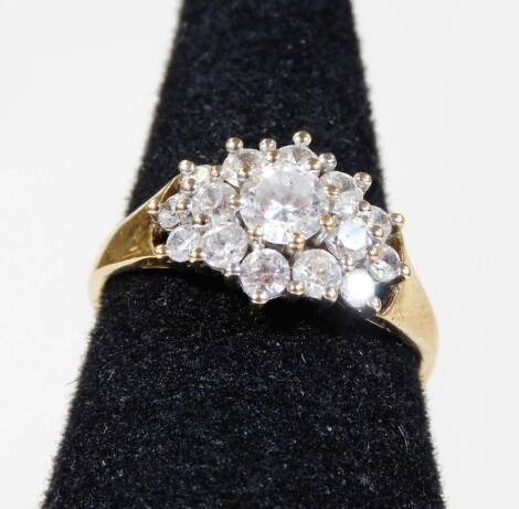 A 9ct gold dress ring, set with various layers of CZ stones, ring size N½, 2.2g all in.