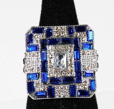 A modern Art Deco style dress ring, of chunky design set with blue and white paste stones, ring size Y.