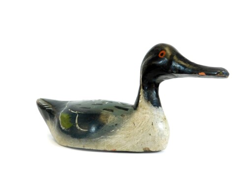 A painted pine folk art duck, probably French, in black white green and yellow colour way, possibly late 19thC, 33cm W.