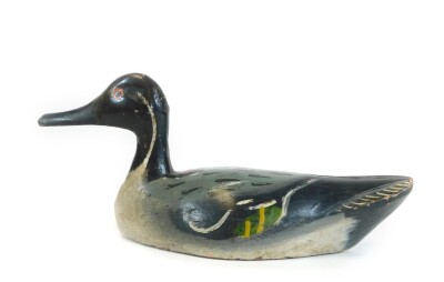 A painted pine folk art duck, probably French, in black white green and yellow colour way, possibly late 19thC, 33cm W. - 2