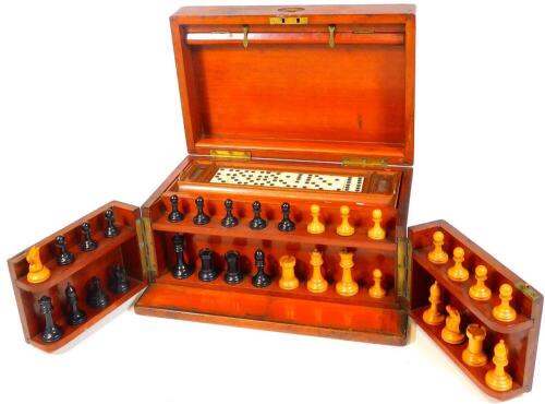 A late 19thC mahogany cased games compendium, containing chess set in the Staunton style with 7.5cm H white king, a lift off tray with dominoes, associated ephemera, etc. when closed 18cm H, 33cm W, 21cm D.