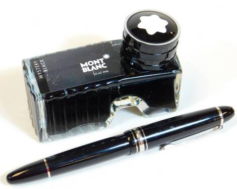 A Mont Blanc fountain pen, in black with chrome coloured banding and star set to the lid, marked two coloured nib, 14cm W, and ink refill.