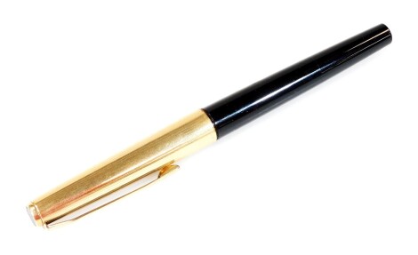 A Pelikan 30 fountain pen, in black and gilt colours with shaped clip, partially enclosed nib, 13cm W.