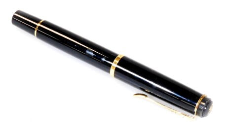 A Pelikan M200 fountain pen, in black and and gilt colours, gilt banding, stamped Pelikan lid, nib stamped F, 12cm W.