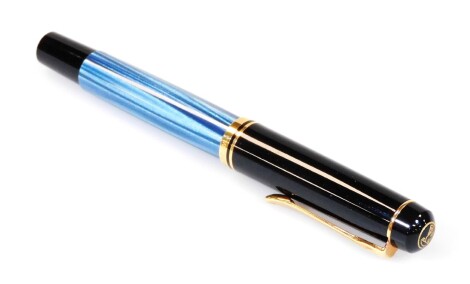 A Pelikan 100 fountain pen, in black and blue textured colours, with gilt coloured banding and clip, stamped nib, 13cm W.