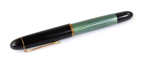 A Pelikan 140 fountain pen, in black and green textured colours with gilt banding and clip, marked nib, 12cm W.