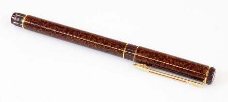 A Waterman Expert fountain pen, in textured brown and gilt colours, with pierced gilt clip, banding with nip stamped M, 14cm W.