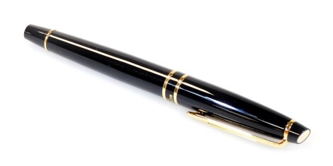 A Waterman fountain pen, stamped Paris in black and gilt coloured with pierced shaped clip, oval insert to the lid, two coloured nib stamped M, 14cm W.