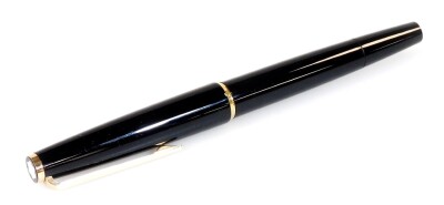 A Montblanc 320 fountain pen, in black with gilt coloured clip and banding, with star top, partially enclosed nip marked 585, 14cm W.