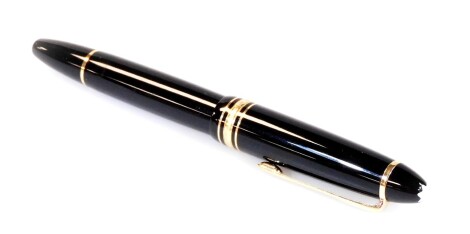 A Montblanc 146 Meisterstuck fountain pen, in black with gilt coloured clip and star to the lip top, 14k nib, 14cm W.