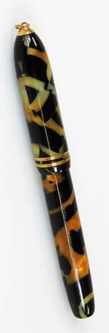 A Conklin Endura fountain pen, in black and orange marble colours with gilt banding and ring top, marked first quality nib, 11cm W.