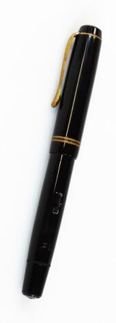 An Osmia Saber Castell fountain pen, in black with double banding and shaped clip, named nib, 13cm W.