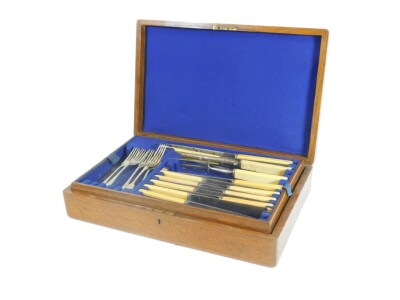 A 20thC oak cased canteen, containing a quantity of plated cutlery, 41cm W. (a quantity)