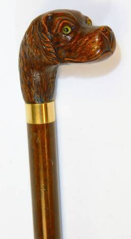 A 20thC walking stick, with carved dog head and plain cylindrical stem with metal collar, 88cm H.